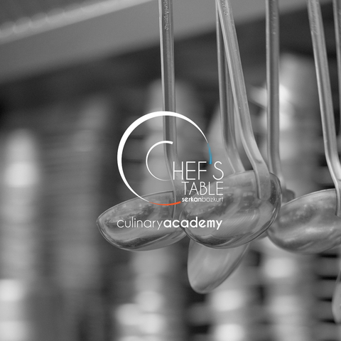 A close-up of ladles in a professional kitchen, showcasing culinary tools.