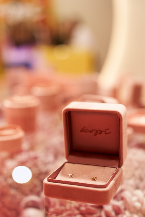 Elegant pair of earrings presented in a pink jewelry box, perfect for a gift or special occasion.